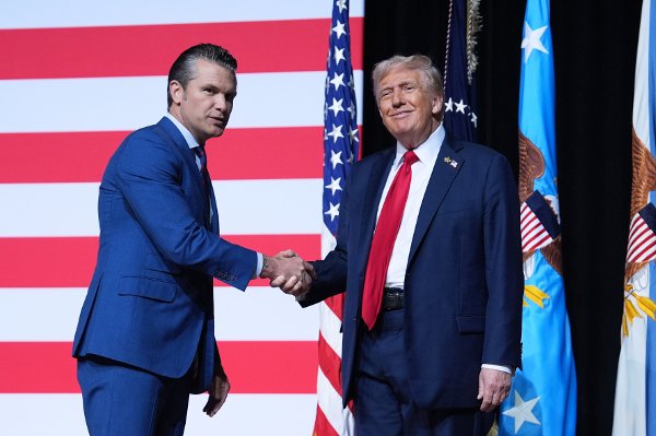 President Donald Trump is greeted by Secretary of Defense Pete Hegseth before speaking to a gathering of top U.S. military commandoers at Marine Corps Base Quantico, Tuesday, Sept. 30, 2025, in Quantico, Va. (AP Photo/Evan Vucci)