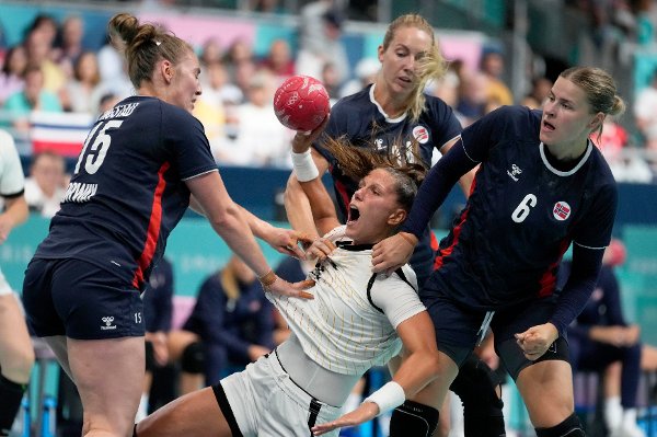 Xenia Smits, of Germany, center, attempts to score past Norway players, at the women's handball match at the 2024 Summer Olympics, Saturday, Aug. 3, 2024, in Paris, France. (AP Photo/Brian Inganga)