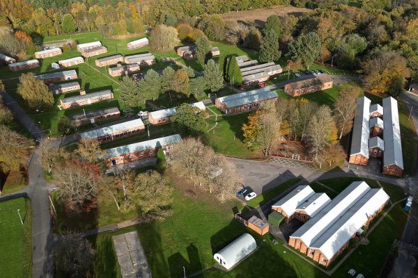 An aerial view shows buildings at Crowborough Training Camp, in Crowborough, south east England on October 28, 2025. The UK government advised the local council on Tuesday that it intends to use the Military Barracks as a temporary asylum accommodation centre for up to 12 months from the end of November 2025. (Photo by JUSTIN TALLIS / AFP)