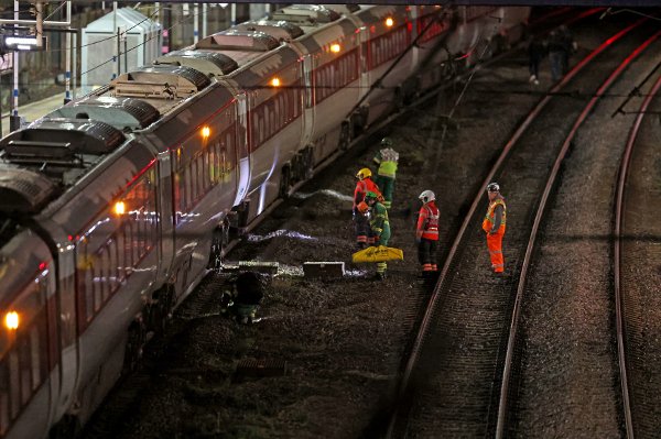 Emergency personnel inspect a train at the Huntingdon, England, train station in Cambridgeshire after people were stabbed Saturday, Nov. 1, 2025. (Chris Radburn/PA via AP)