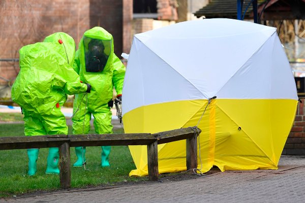 (FILES) In this file photo taken on March 8, 2018 members of the emergency services in green biohazard encapsulated suits afix the tent over the bench where a man and a woman were found on March 4 in critical condition at The Maltings shopping centre in Salisbury, southern England, after the tent became detached. - A fresh round of sanctions were imposed on Moscow on August 3, 2019 by the United States over the 2018 poisoning of former double-agent Sergei Skripal in the United Kingdom. (Photo by Ben STANSALL / AFP)
