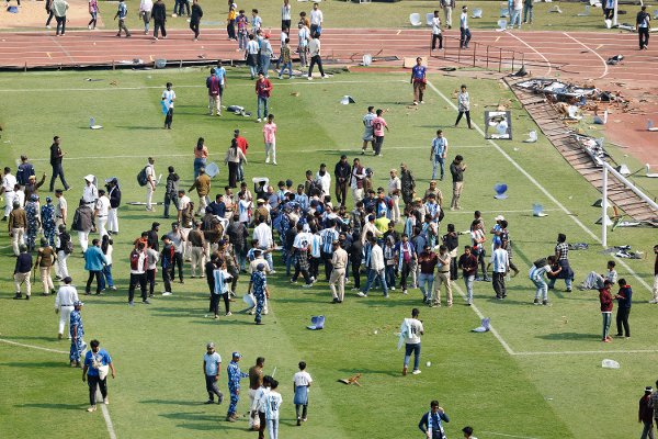 Soccer Football - Argentine soccer star Lionel Messi on a whirlwind tour of India - Vivekananda Yuva Bharati Krirangan, Kolkata, India - December 13, 2025
Riot police and fans are seen on the pitch after Argentine soccer star Lionel Messi leaves the stadium REUTERS/Sahiba Chawdhary