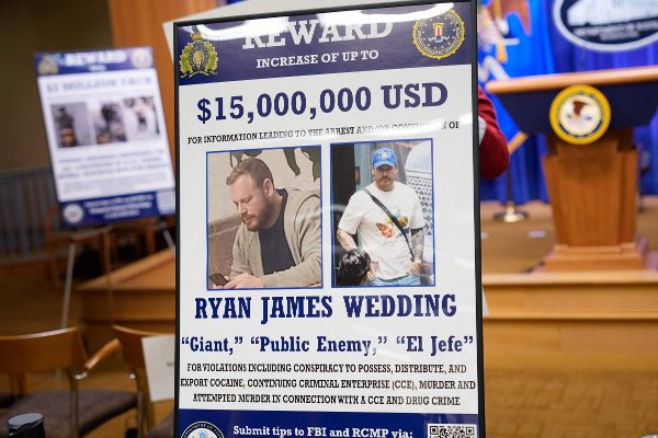 WASHINGTON, DC - NOVEMBER 19: A reward poster for the arrest of Ryan James Wedding is visible following a news conference announcing the indictment of a former Olympic snowboarder Ryan Wedding, charging him with murder and money laundering in connection to a drug trafficking organization at the Justice Department on November 19, 2025 in Washington, DC. The Justice Department announced a fifteen-million-dollar reward for information leading to the arrest of Ryan James Wedding, the leader of a criminal drug organization who smuggled large quantities of cocaine through Colombia and Mexico for distribution in the United States and Canada.   Andrew Harnik/Getty Images/AFP (Photo by Andrew Harnik / GETTY IMAGES NORTH AMERICA / Getty Images via AFP)