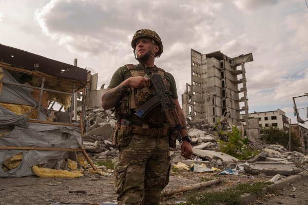 Ukrainian serviceman Dmytro observes area in front of a building destroyed by a Russian airstrike, while patrolling in Myrnohrad, Ukraine, Tuesday, Sept. 17, 2024. (AP Photo/Evgeniy Maloletka)