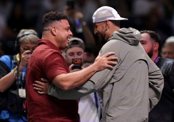 Nick Kyrgios, right, interacts with former footballer Ronaldo after the Battle of the Sexes match between Aryna Sabalenka and Nick Kyrgios, in Dubai, United Arab Emirates, Sunday Dec. 28, 2025. (Christopher Pike/Pool Photo via AP)