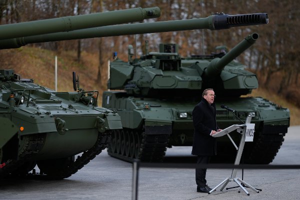 German Defence Minister Boris Pistorius speaks in front of new Leopard 2A8 main battle tank and a new howitzer PzH2000 during a rollout event in Munich, Germany, Wednesday, Nov. 19, 2025. (AP Photo/Matthias Schrader)