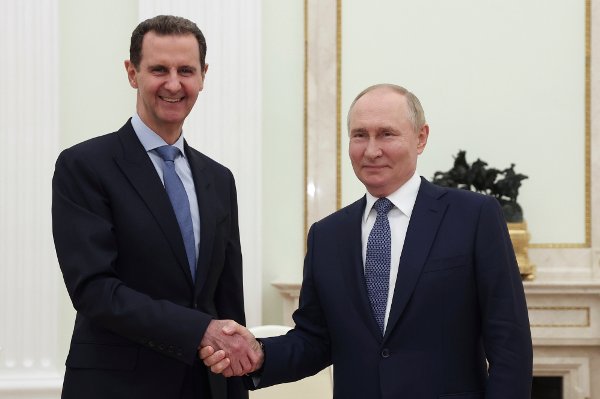 Syrian President Bashar Assad, left, and Russian President Vladimir Putin shake hands during their meeting in Moscow, Russia, Wednesday, July 24, 2024. (Valery Sharifulin, Sputnik, Kremlin Pool Photo via AP)