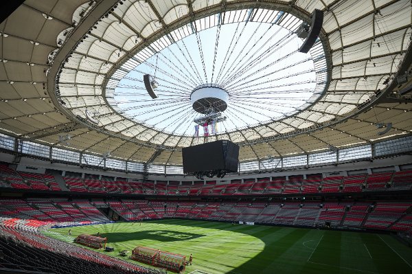 Stadium staff prepare temporary grass that was laid on top of artificial turf at BC Place stadium for a friendly soccer match between MLS soccer's Vancouver Whitecaps and League One's Wrexham, in Vancouver, on Friday, July 26, 2024. The stadium, which is undergoing hundred of millions of dollars of renovations, is also scheduled to host seven matches during the 2026 FIFA World Cup. THE CANADIAN PRESS/Darryl Dyck