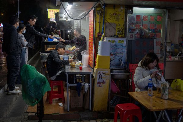 A food vendor serves customers on the streets of Guangzhou in southern China's Guangdong province on Monday, Nov. 3, 2025. (AP Photo/Ng Han Guan)