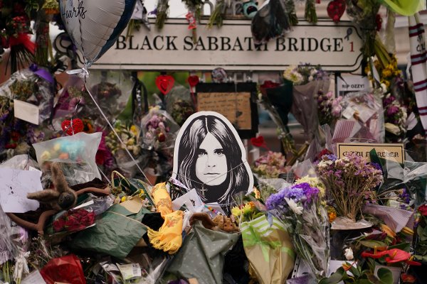 Floral tributes in front of the 'Black Sabath bridge' to honour musician Ozzy Osbourne as thousands of fans gathered to watch a funeral procession for Black Sabbath frontman Ozzy Osbourne following his death aged 76, in Birmingham, England, Wednesday, July 30, 2025. (AP Photo/Alberto Pezzali)
