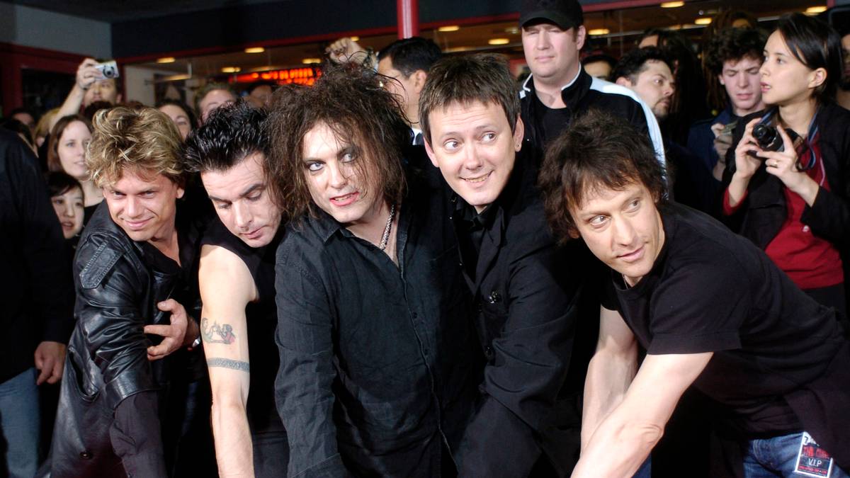 (l-r) Jason Cooper, Simon Gallup, Robert Smith, Roger O'Donnell and Perry Bamonte of British rock group The Cure put their hands in cement at Hollywood's Rockwalk in Los Angeles, Friday, April 30, 2004. Formed in 1976 by frontman Smith, The Cure has sold more than 28 million albums worldwide. (AP Photo/Chris Pizzello)