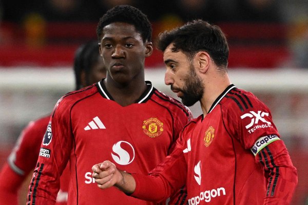 Manchester United's Portuguese midfielder #08 Bruno Fernandes (R) talks with Manchester United's English midfielder #37 Kobbie Mainoo (L) during the English Premier League football match between Manchester United and Bournemouth at Old Trafford in Manchester, north west England, on December 15, 2025. (Photo by PETER POWELL / AFP) / RESTRICTED TO EDITORIAL USE. No use with unauthorized audio, video, data, fixture lists, club/league logos or 'live' services. Online in-match use limited to 120 images. An additional 40 images may be used in extra time. No video emulation. Social media in-match use limited to 120 images. An additional 40 images may be used in extra time. No use in betting publications, games or single club/league/player publications. / 