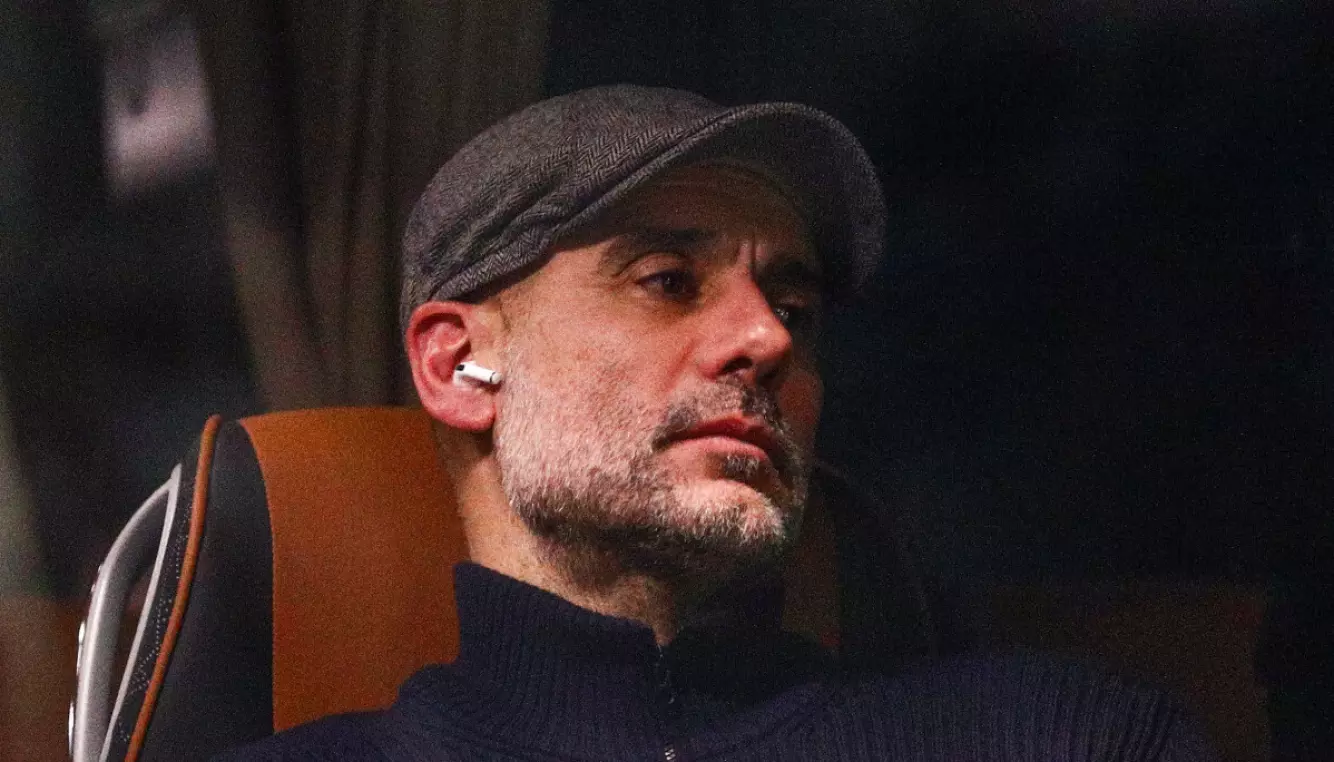 BETENKT: Pep Guardiola så ut til å ha musikk på øret da han forlot Aspmyra. Foto: Mats Torbergsen / NTB