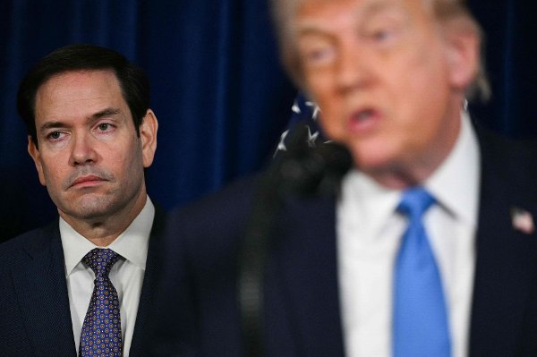 (L/R) US Secretary of State Marco Rubio looks on as US President Donald Trump speaks to the press following US military actions in Venezuela, at his Mar-a-Lago residence in Palm Beach, Florida, on January 3, 2025. President Trump said Saturday that US forces had captured Venezuelan leader Nicolas Maduro after launching a 