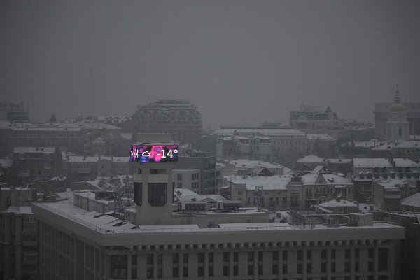 This photograph shows a big screen on a building displaying a temperature of -14 degrees Celsius in Kyiv on January 14, 2026, amid the Russian invasion of Ukraine. (Photo by Sergei GAPON / AFP)