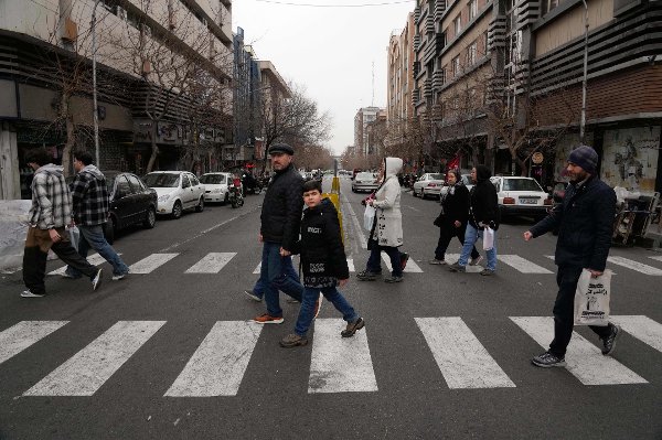 People cross an intersection in downtown Tehran, Iran, Thursday, Jan. 15, 2026. (AP Photo/Vahid Salemi)