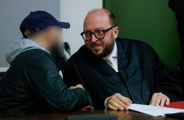Defendant Dieter S (L) talks with his lawyer Michael Loewe as he waits at court for his verdict in his trial for spying for Moscow and readying attacks on critical military infrastructure and industry in a court in Munich, southern Germany, on October 30, 2025. The court will deliver its verdict in the trial of a German-Russian national on charges of spying for Moscow and plotting sabotage acts to undermine Germany's support for Ukraine. The defendant, named as Dieter S., is thought to be an example of what Germany refers to as