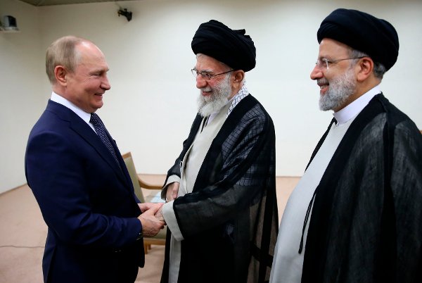 In this picture released by the official website of the office of the Iranian supreme leader, Supreme Leader Ayatollah Ali Khamenei, center, and Russian President Vladimir Putin, left, greet each other as Iranian President Ebrahim Raisi stands at right, during their meeting in Tehran, Iran, Tuesday, July 19, 2022. (Office of the Iranian Supreme Leader via AP)