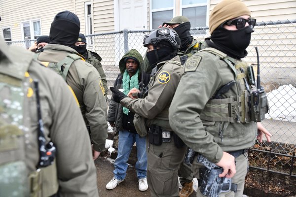 US Border Patrol agents detain an unidentified man of Somali descent in Minneapolis, Minnesota, on January 8, 2026. A US Immigration and Customs Enforcement (ICE) agent shot and killed an American woman on the streets of Minneapolis January 7, leading to huge protests and outrage from local leaders who rejected White House claims she was a domestic terrorist. The woman, identified in local media as 37-year-old Renee Nicole Good, was hit at point blank range as she apparently tried to drive away from agents who were crowding around her car, which they said was blocking their way. (Photo by Octavio JONES / AFP)