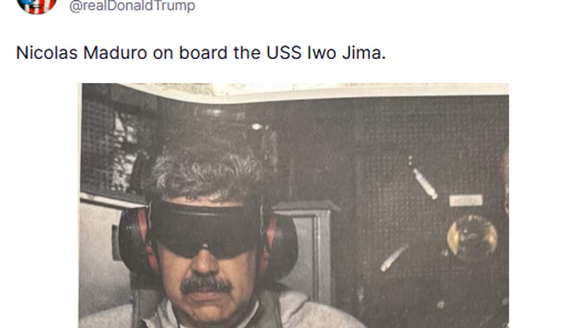 En person står på et skip med hodetelefoner og holder en flaske vann. Personen er iført grå klær og er omgitt av mørke, uidentifiserte bakgrunnselementer. Det er et klart fokus på individet og handlingen med lite visuell støy rundt. Bildet ser ut til å være knyttet til en spesifikk hendelse om bord i USS Iwo Jima. (Bildebeskrivelsen er laget av en KI-tjeneste)