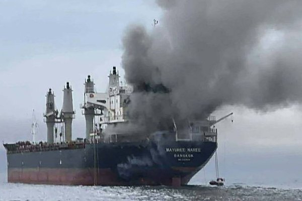 This handout photo taken on March 11, 2026 and released by the Royal Thai Navy shows smoke rising from the Thai bulk carrier 'Mayuree Naree' near the Strait of Hormuz after an attack. A Thai bulk carrier travelling in the crucial Strait of Hormuz was attacked March 11, with 20 crew members rescued so far, the Thai navy said. (Photo by Handout / ROYAL THAI NAVY / AFP) / -----EDITORS NOTE --- RESTRICTED TO EDITORIAL USE - MANDATORY CREDIT 
