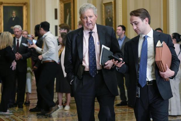 Sen. John Kennedy, R-La., center, speaks with a reporter.