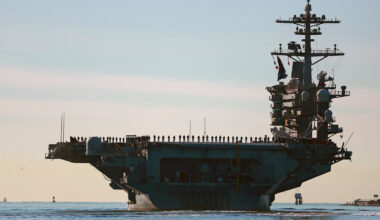 FILE - Sailors and Marines line the deck of aircraft carrier USS Abraham Lincoln (CVN-72) as it deploys from San Diego, Jan. 3, 2021. (K.C. Alfred/The San Diego Union-Tribune via AP, File)