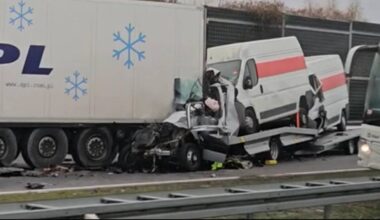 Zmiażdżona szoferka lawety z dwoma busami na pokładzie po zderzeniu z tyłem białej ciężarówki na autostradzie.