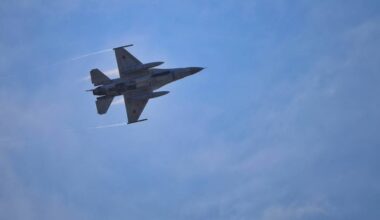 Myśliwiec wojskowy w locie na tle nieba.