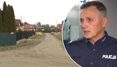 Policjant udziela wywiadu na tle osiedla domów jednorodzinnych.