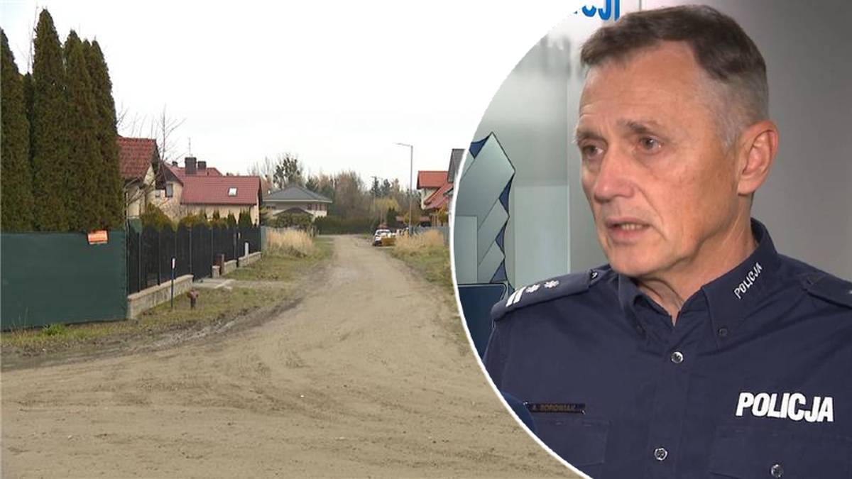 Policjant udziela wywiadu na tle osiedla domów jednorodzinnych.