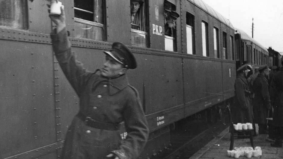 Żołnierz Korpusu Ochrony Pogranicza przed wagonem PKP na dworcu w Stołpcach, 1932 r.