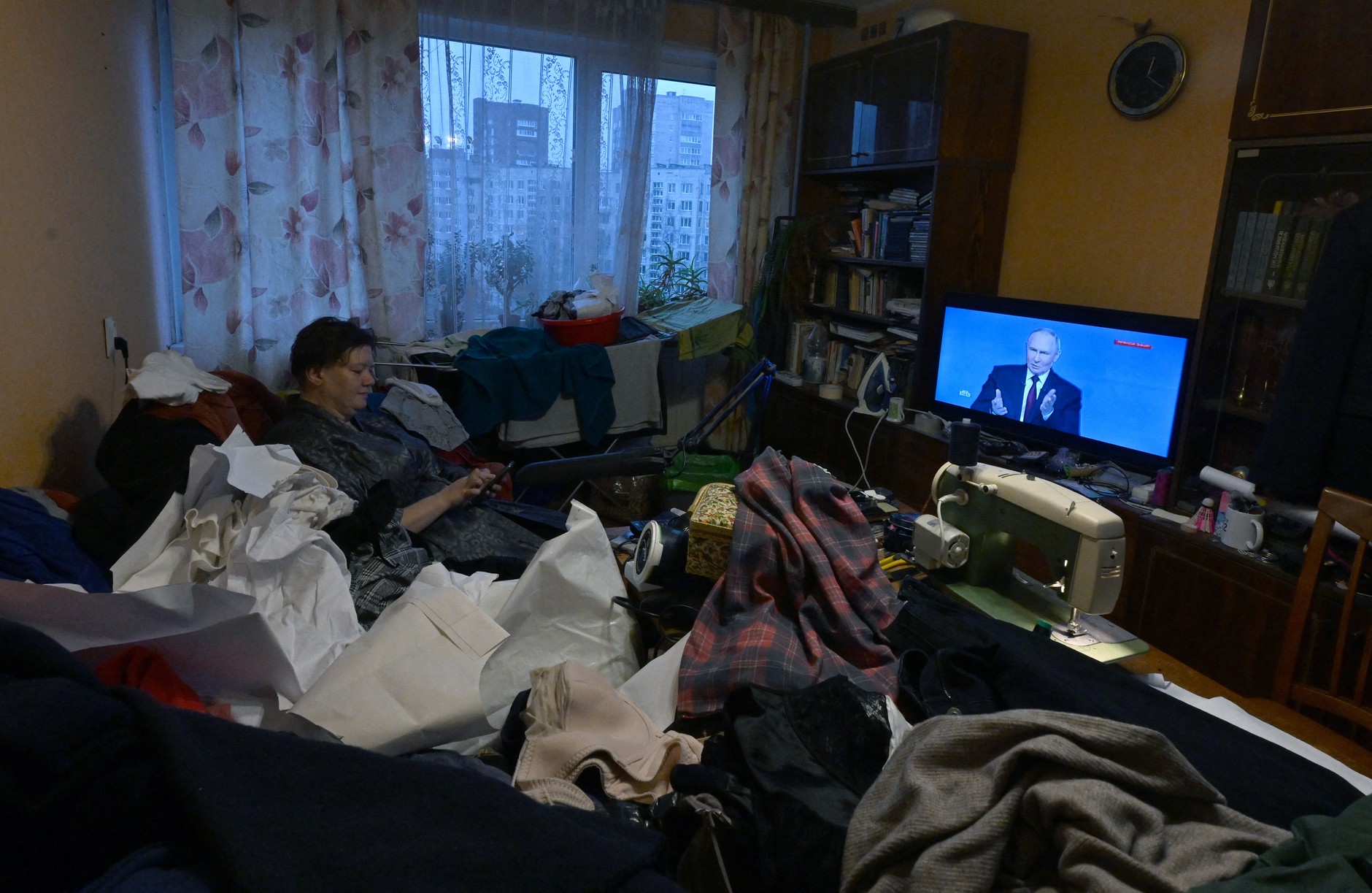 Rosjanka ogląda transmisję telewizyjną z corocznej konferencji prasowej Władimira Putina w swoim mieszkaniu w Sankt Petersburgu, Rosja, 19 grudnia 2025 r.