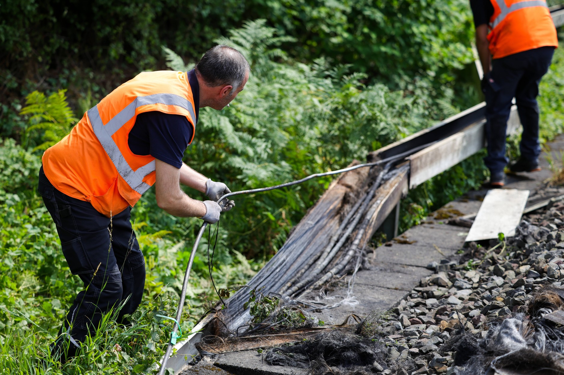 Pracownicy Deutsche Bahn kontrolują odcinek torów po pożarze, który uszkodził kable. Duesseldorf, 31 lipca 2025 r.