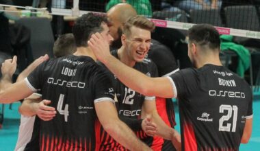 Siatkarze w czarnych strojach świętują razem na boisku.