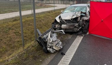 Zniszczone samochody po wypadku drogowym na poboczu drogi, obok widoczny znak drogowy "Prząsław" i czerwony namiot