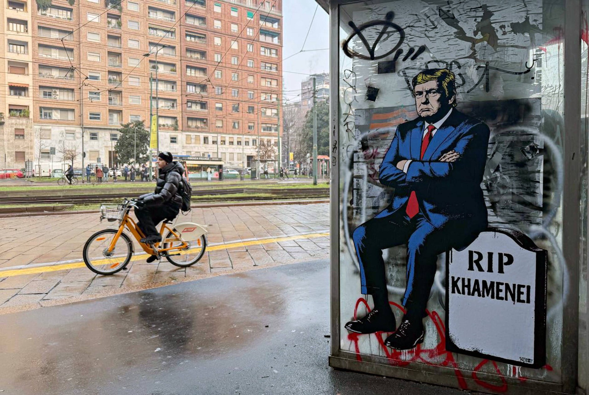 Mural włoskiego artysty aleXsandro Palombo przedstawiający Donalda Trumpa siedzącego na nagrobku z napisem "RIP Chamenei". Mediola, 16 stycznia 2026 r.