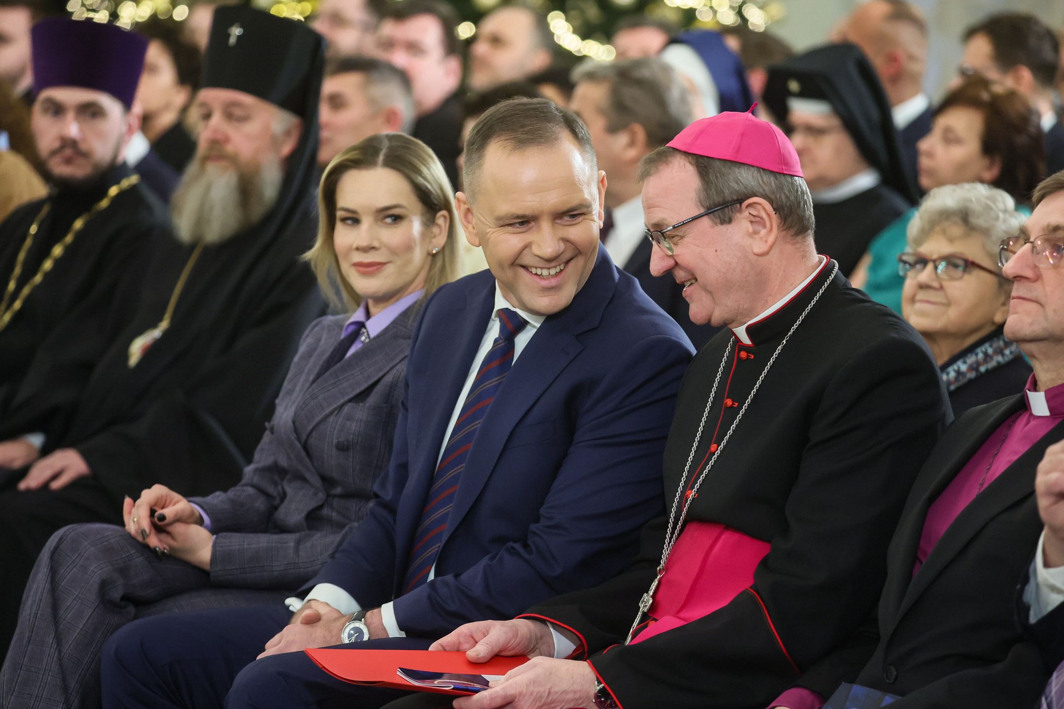 Warszawa, 14.01.2026. Prezydent RP Karol Nawrocki (C), pierwsza dama Marta Nawrocka (C-L) i przewodniczący Konferencji Episkopatu Polski abp Tadeusz Wojda (C-P) na spotkaniu noworocznym z przedstawicielami kościołów i związków wyznaniowych oraz mniejszości narodowych i etnicznych w Polsce, 14 bm. w Pałacu Prezydenckim w Warszawie. (mr) PAP/Leszek Szymański