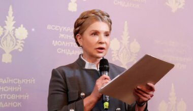 Julia Tymoszenko przemawia do mikrofonu z dokumentami w ręku.