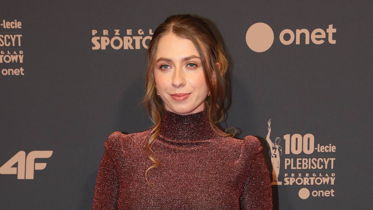 Kobieta w błyszczącej sukni na czerwonym dywanie podczas gali Sportowca Roku.