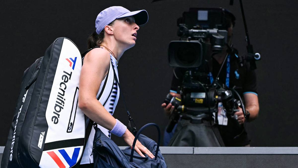 Tenisistka z torbą na ramieniu i plecakiem, idąca obok operatora kamery.