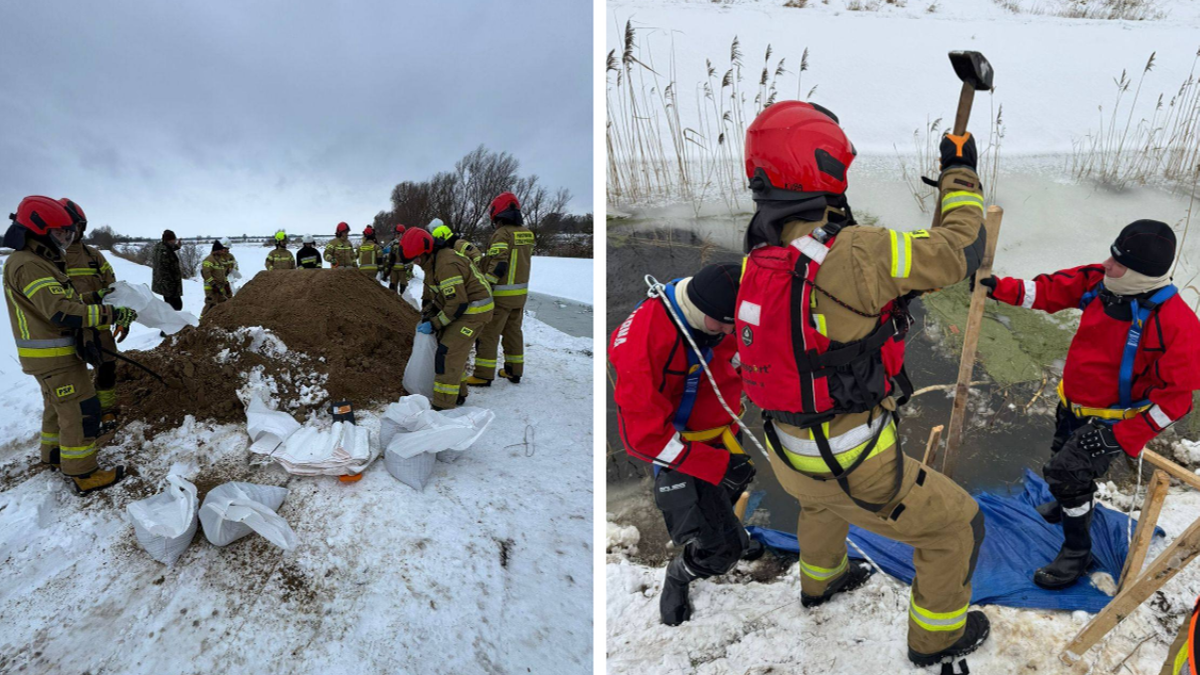 Strażacy pracują w zasypanym śniegiem terenie, układając worki z piaskiem w pobliżu przerwanego wału.