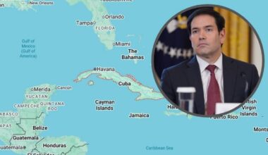 Mapa regionu Karaib&oacute;w z zaznaczonymi państwami i wizerunkiem mężczyzny w garniturze.