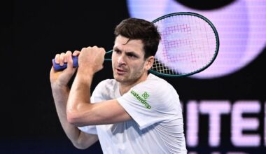 Tenisista Hubert Hurkacz podczas meczu, trzymający rakietę oburącz i przygotowujący się do uderzenia.