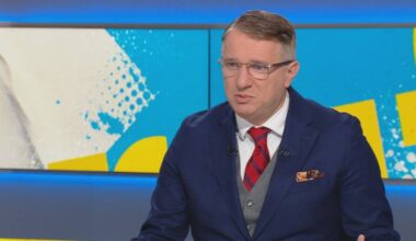 Poseł Konfederacji Przemysław Wipler w okularach i granatowym garniturze z czerwonym krawatem.