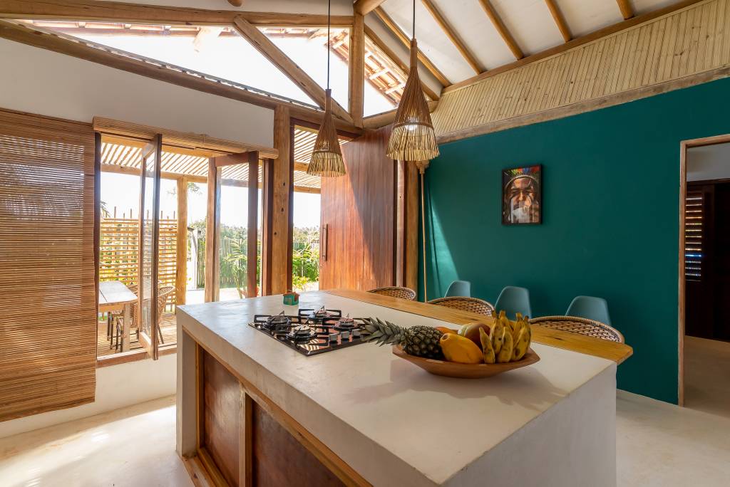 Casa pátio de praia na Bahia foi erguida em torno das árvores. Projeto de Mari Grobério. Na foto, cozinha com ilha.