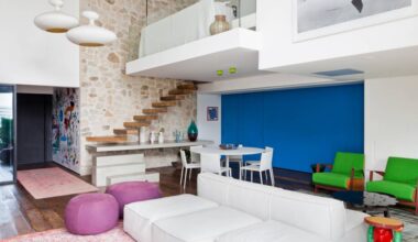 Cheio de estilo, apartamento moderno tem parede azul, parede de pedras e mezanino