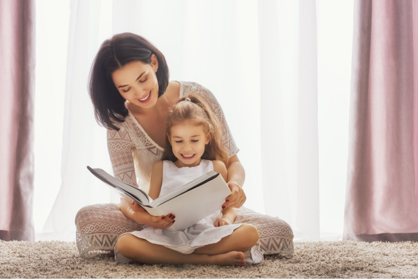 mãe lendo livros de romance com a sua filha