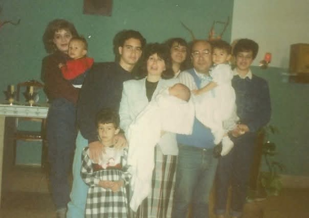 Lindaura e José Camilo com os oito filhos no batizado de Thiago, um deles. Chris aparece em pé segurando o irmão Rafael, gêmeo de Gabriela, no colo do pai — Foto: Arquivo pessoal