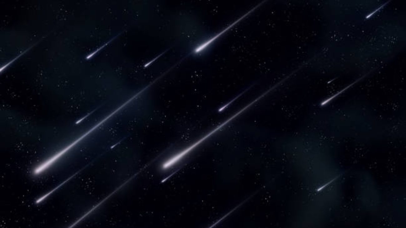 Imagem de meteoros cruzando o céu noturno, criando um espetáculo de luzes no espaço.